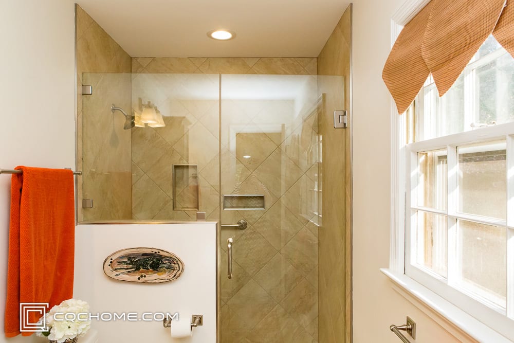 Light tan bathroom with glass shower