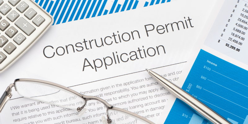  construction permit application with pen and calculator 