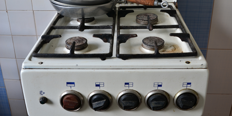  Old gas stove with cooking pans 
