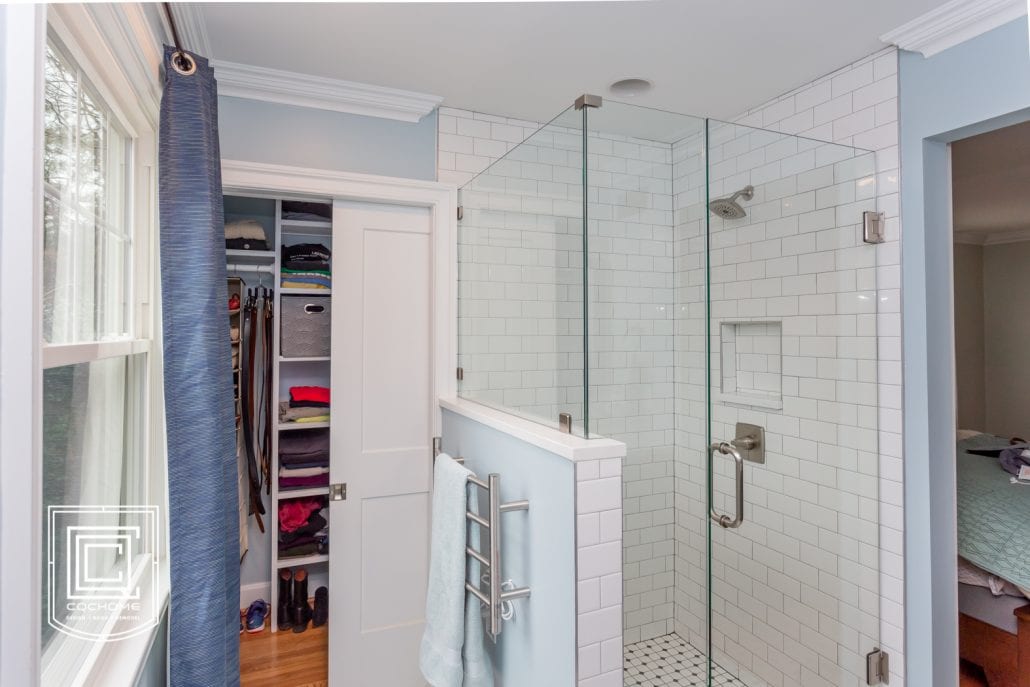 bathroom with glass shower and closet