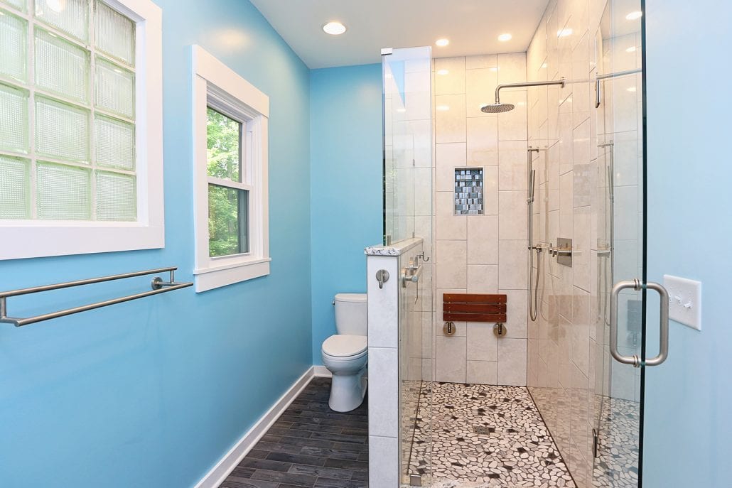 Blue bathroom with small updated walk in shower