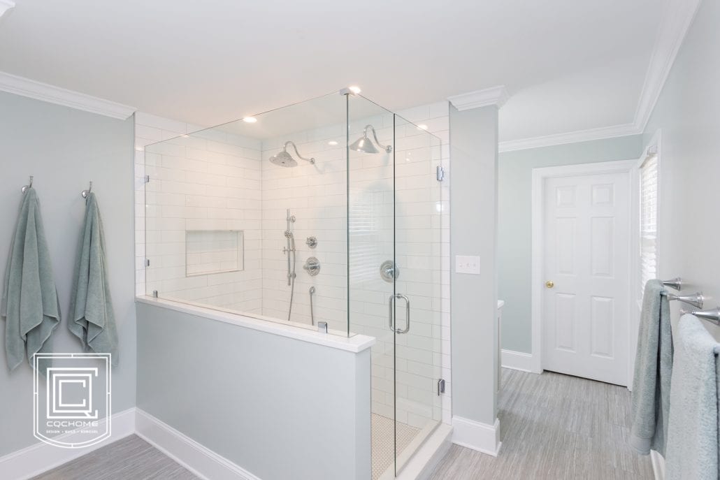 Gray and white bathroom with large walk in shower with white subway tile.
